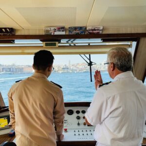 Ship captain and crew member discussing navigation on the Bosphorus in Istanbul.